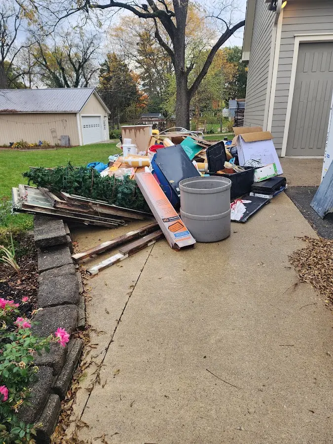 Dumpster being loaded with debris for Estate Cleanout Dumpster Rental in Winston